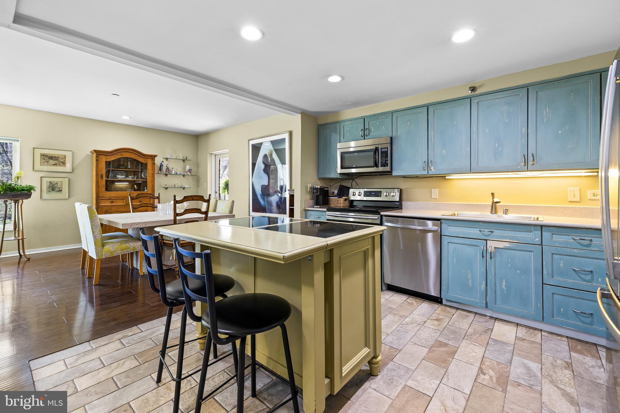 2331 Old Court Road, Unit 307 Baltimore, MD 21208 - Photo 14 of 54 a kitchen with a table chairs sink and cabinets