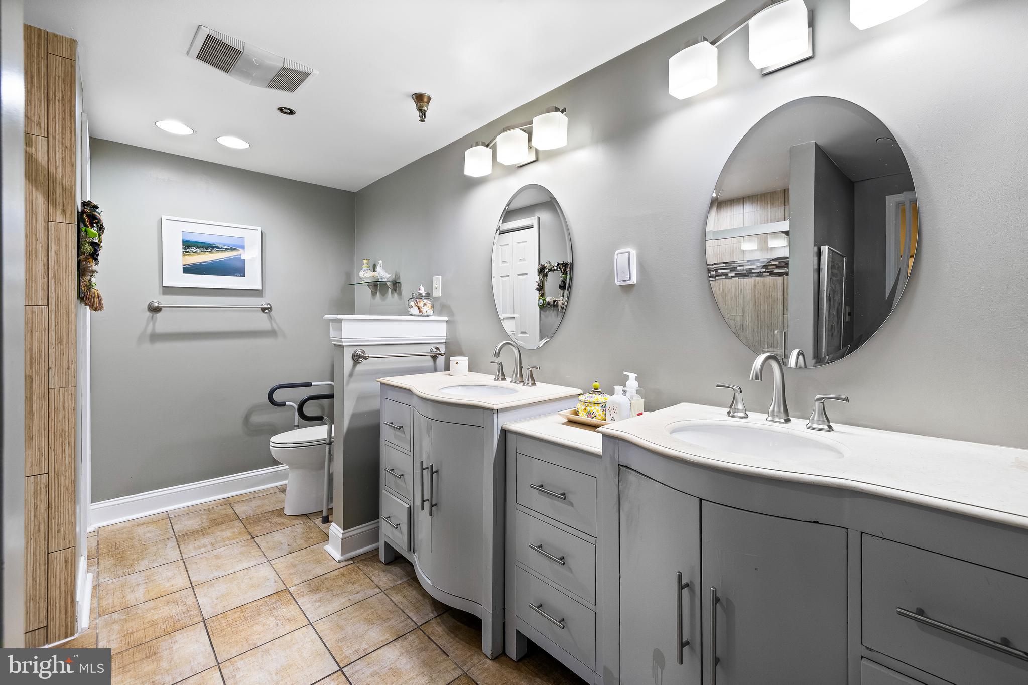 2331 Old Court Road, Unit 307 Baltimore, MD 21208 - Photo 25 of 54 a spacious bathroom with a double vanity sink and a mirror