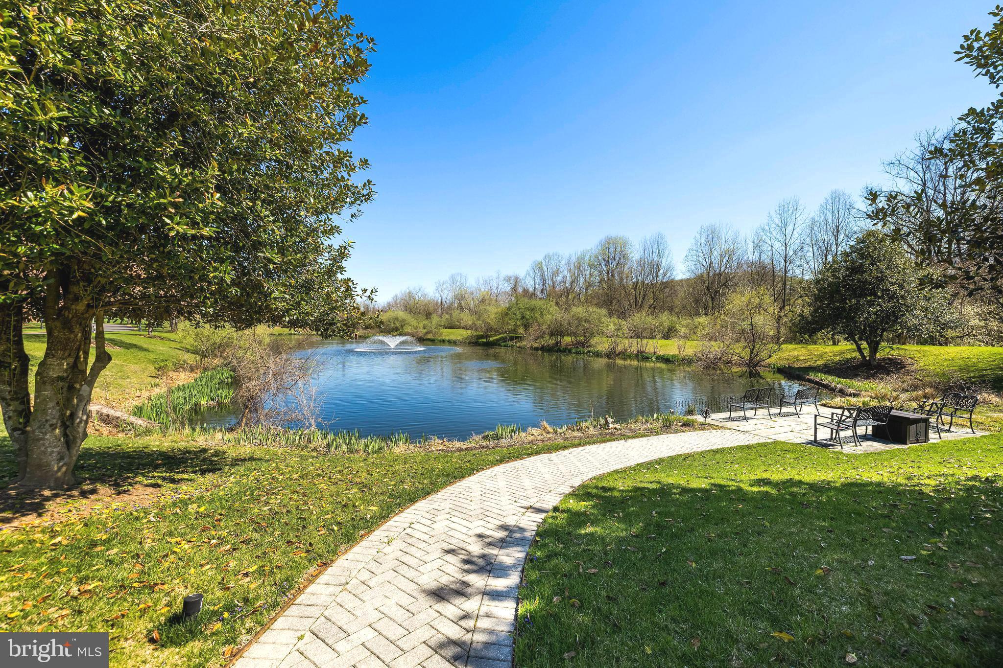 2331 Old Court Road, Unit 307 Baltimore, MD 21208 - Photo 3 of 54 a view of a lake with houses in the back