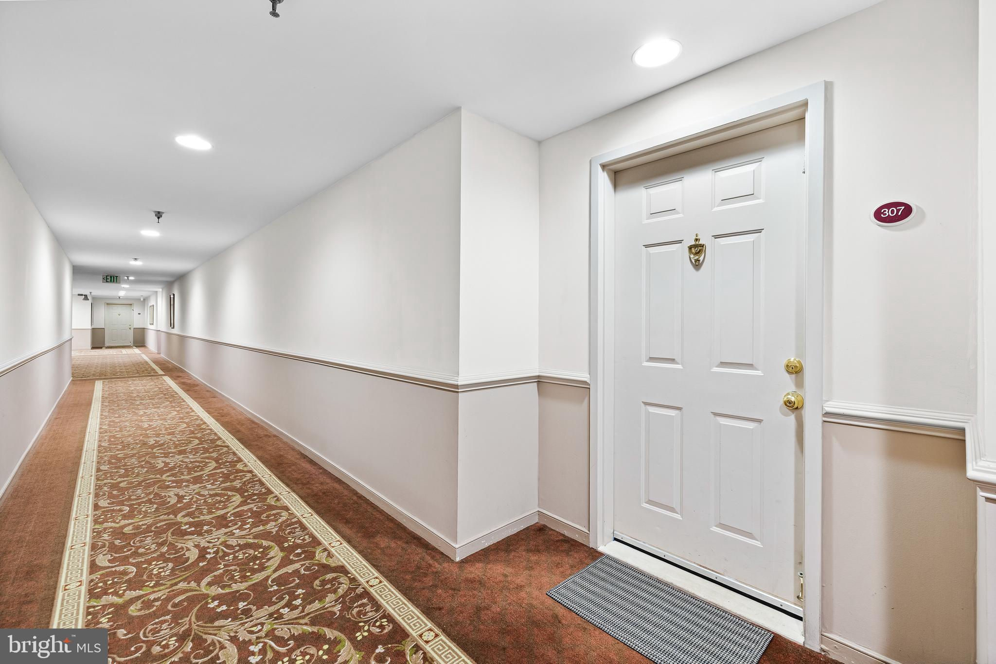 2331 Old Court Road, Unit 307 Baltimore, MD 21208 - Photo 51 of 54 a view of a hallway with wooden floor and staircase