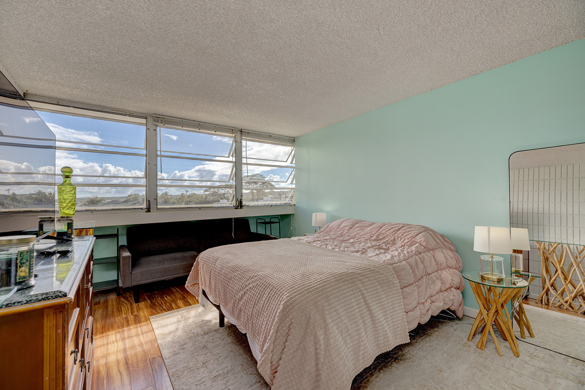 84 Pukihae Street, Unit 406 Hilo, HI 96720 - Photo 15 of 26 a bed sitting in a bedroom next to a window