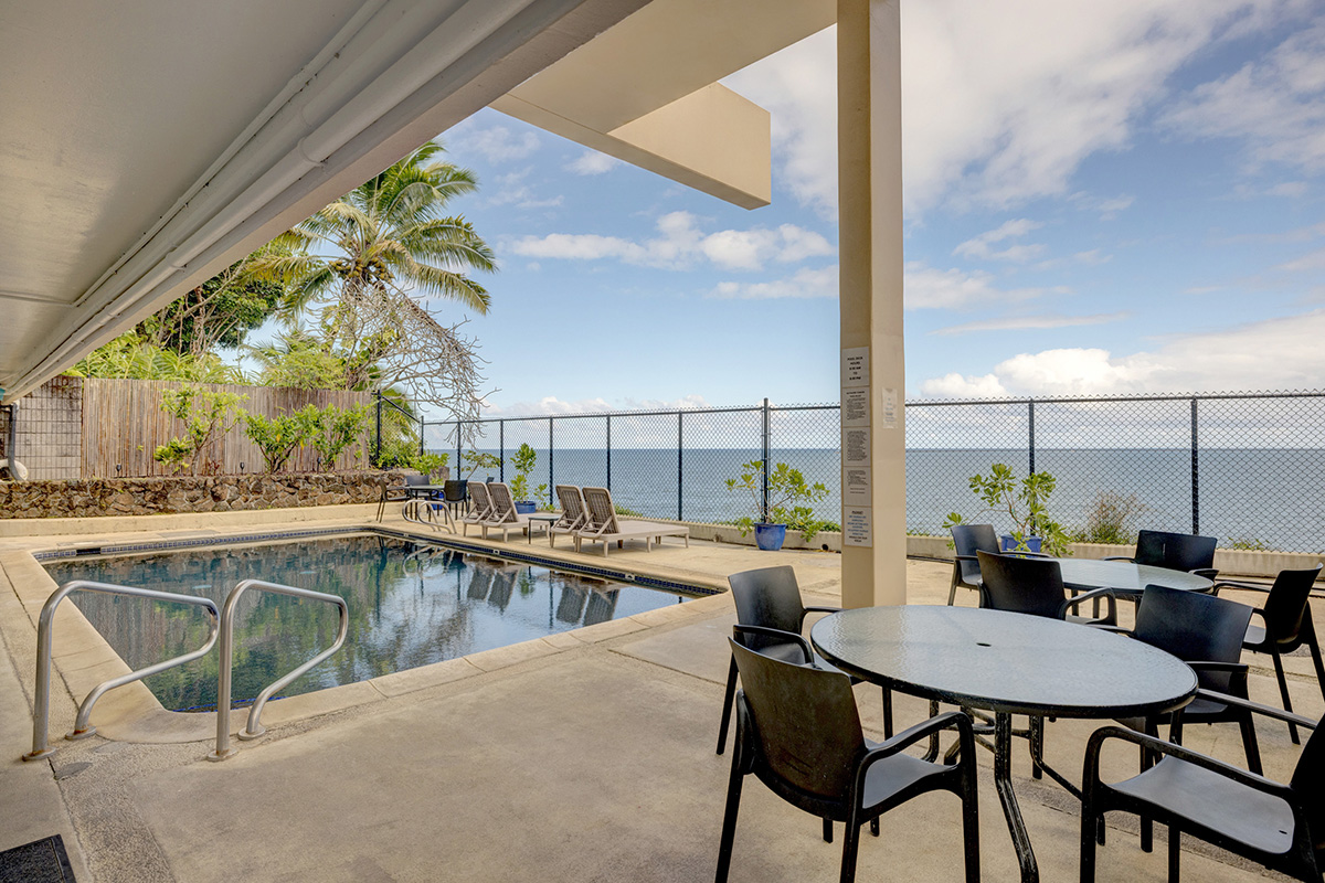 84 Pukihae Street, Unit 406 Hilo, HI 96720 - Photo 17 of 26 a view of a swimming pool with a table and chairs