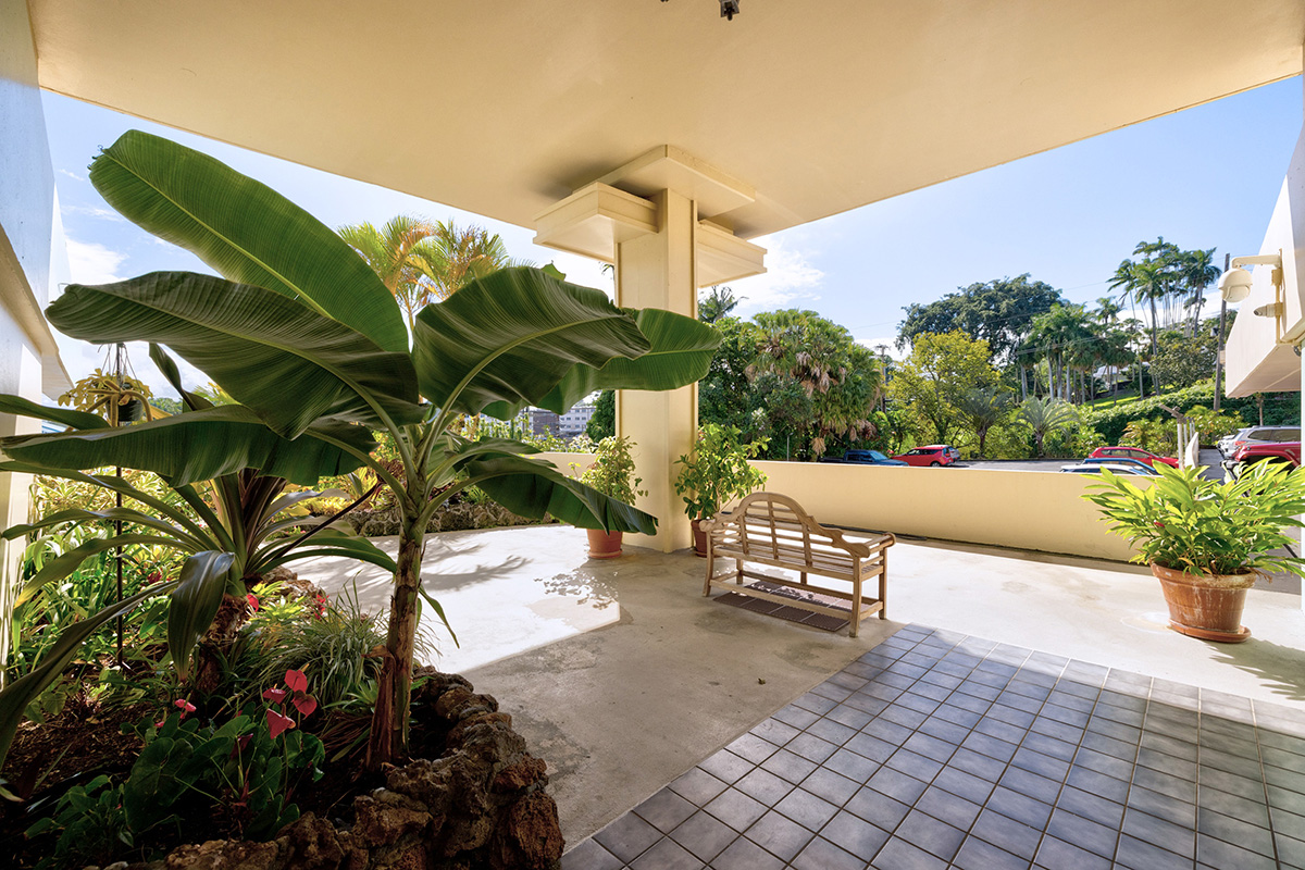 84 Pukihae Street, Unit 406 Hilo, HI 96720 - Photo 25 of 26 a view of a patio with table and chairs potted plants