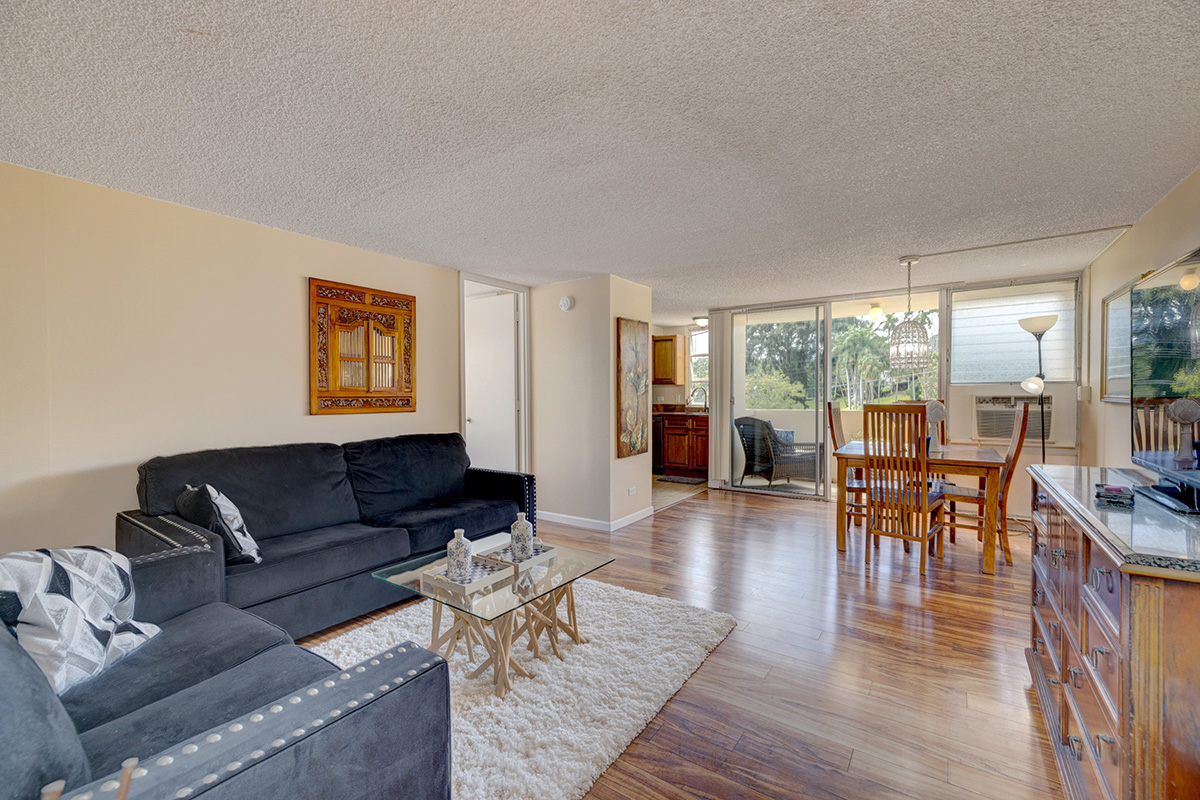 84 Pukihae Street, Unit 406 Hilo, HI 96720 - Photo 4 of 26 a living room with furniture and a wooden floor