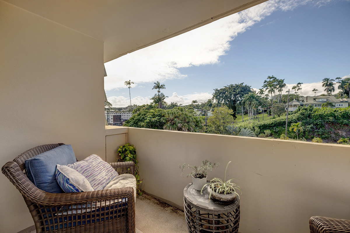 84 Pukihae Street, Unit 406 Hilo, HI 96720 - Photo 6 of 26 a balcony with furniture and flowers