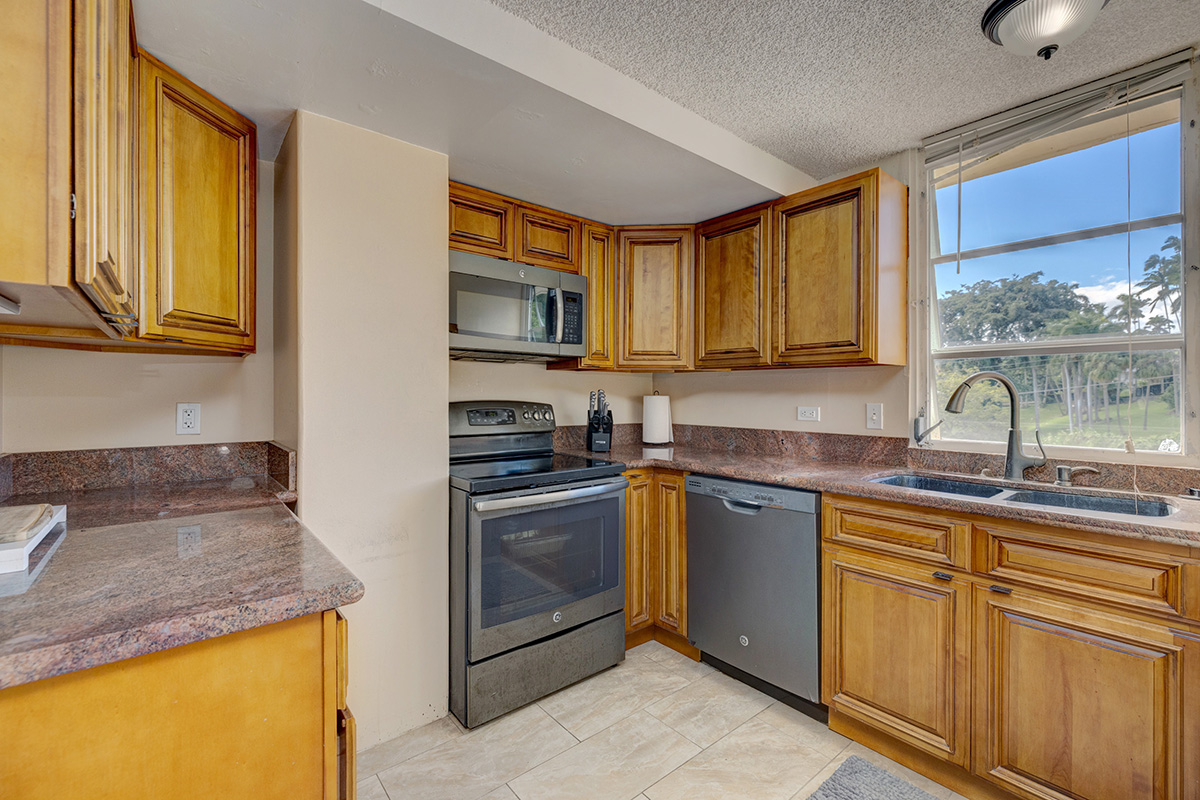 84 Pukihae Street, Unit 406 Hilo, HI 96720 - Photo 8 of 26 a kitchen with stainless steel appliances granite countertop a sink stove and cabinets