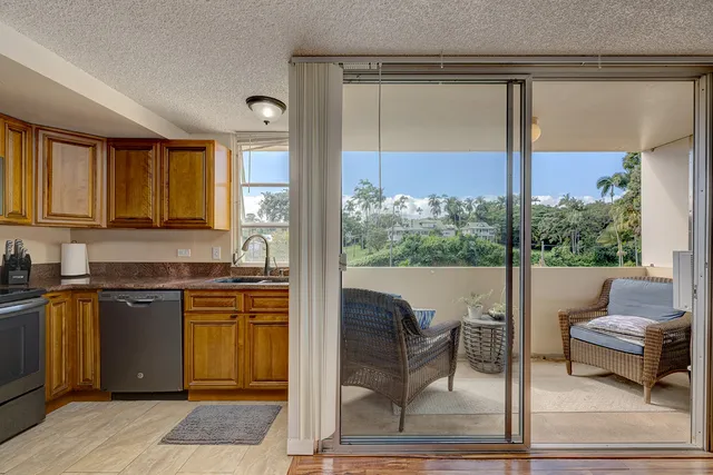 a kitchen with a table chairs and granite counter tops