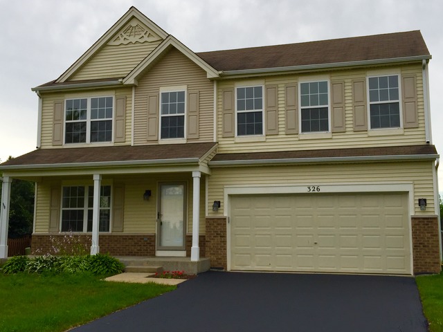 326 Prairie Ridge Drive Minooka, IL 60447 - Photo 1 of 16 a front view of a house with a yard and garage