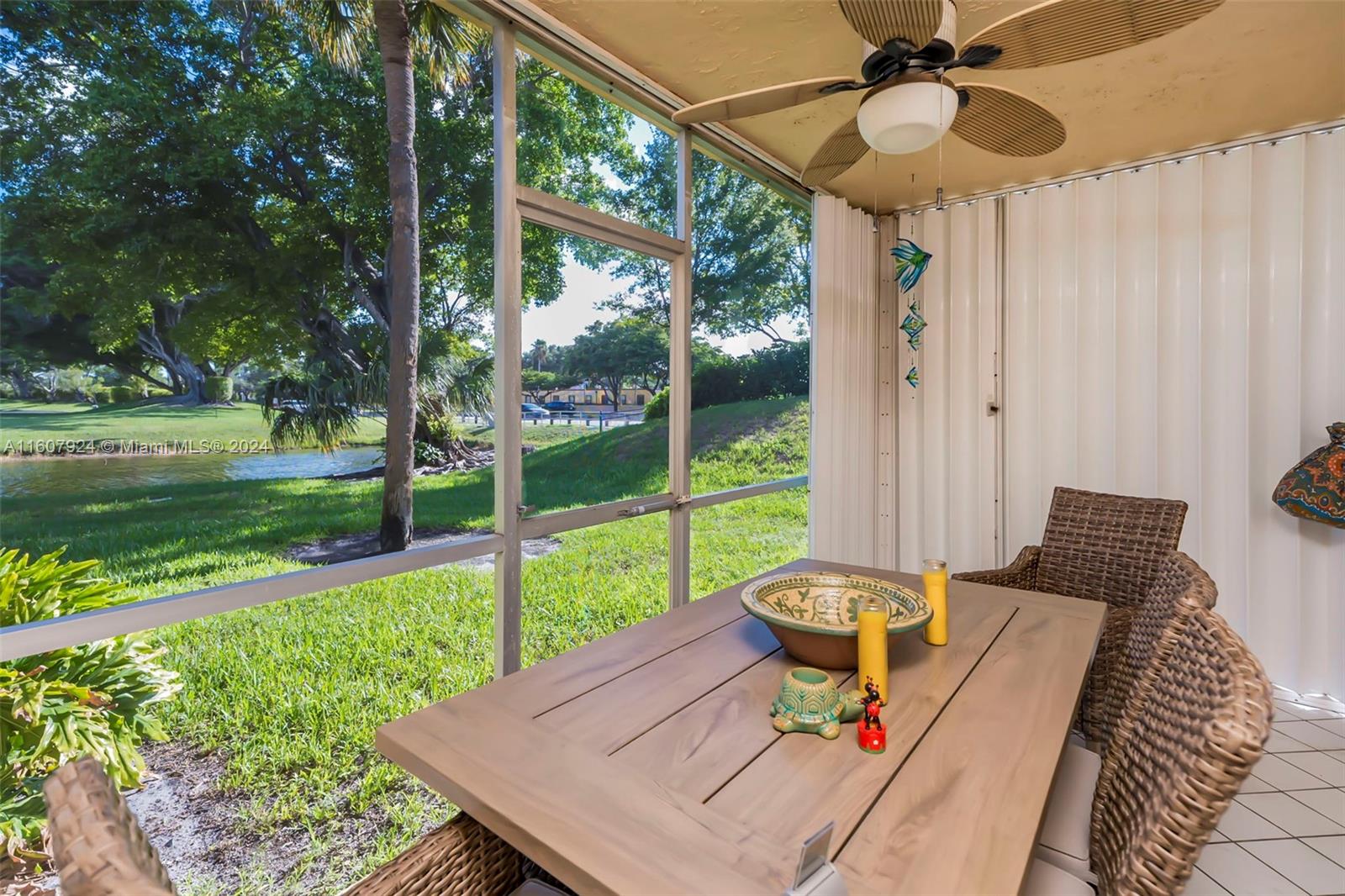 8780 Azalea Court, Unit 104 Tamarac, FL 33321 - Photo 1 of 37 a living room with yard and a floor to ceiling window