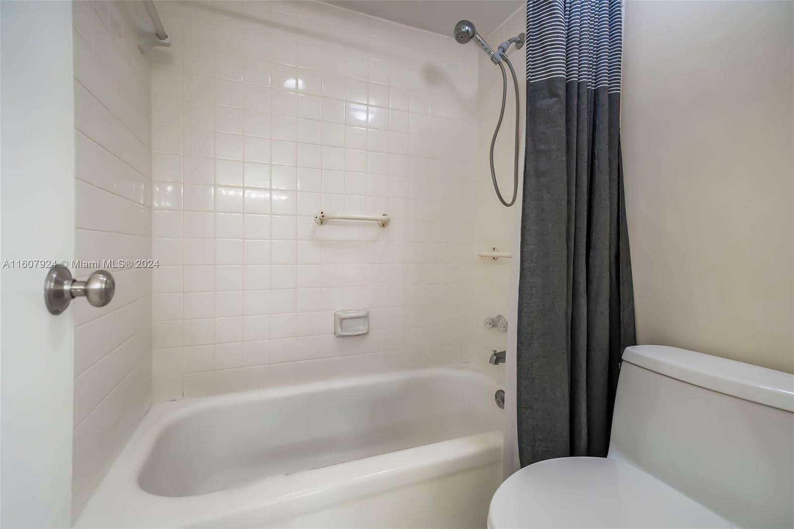 8780 Azalea Court, Unit 104 Tamarac, FL 33321 - Photo 12 of 37 a bathroom with a tub toilet and shower