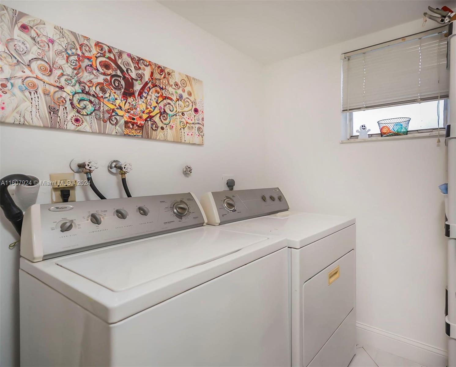 8780 Azalea Court, Unit 104 Tamarac, FL 33321 - Photo 17 of 37 a utility room with dryer and washer