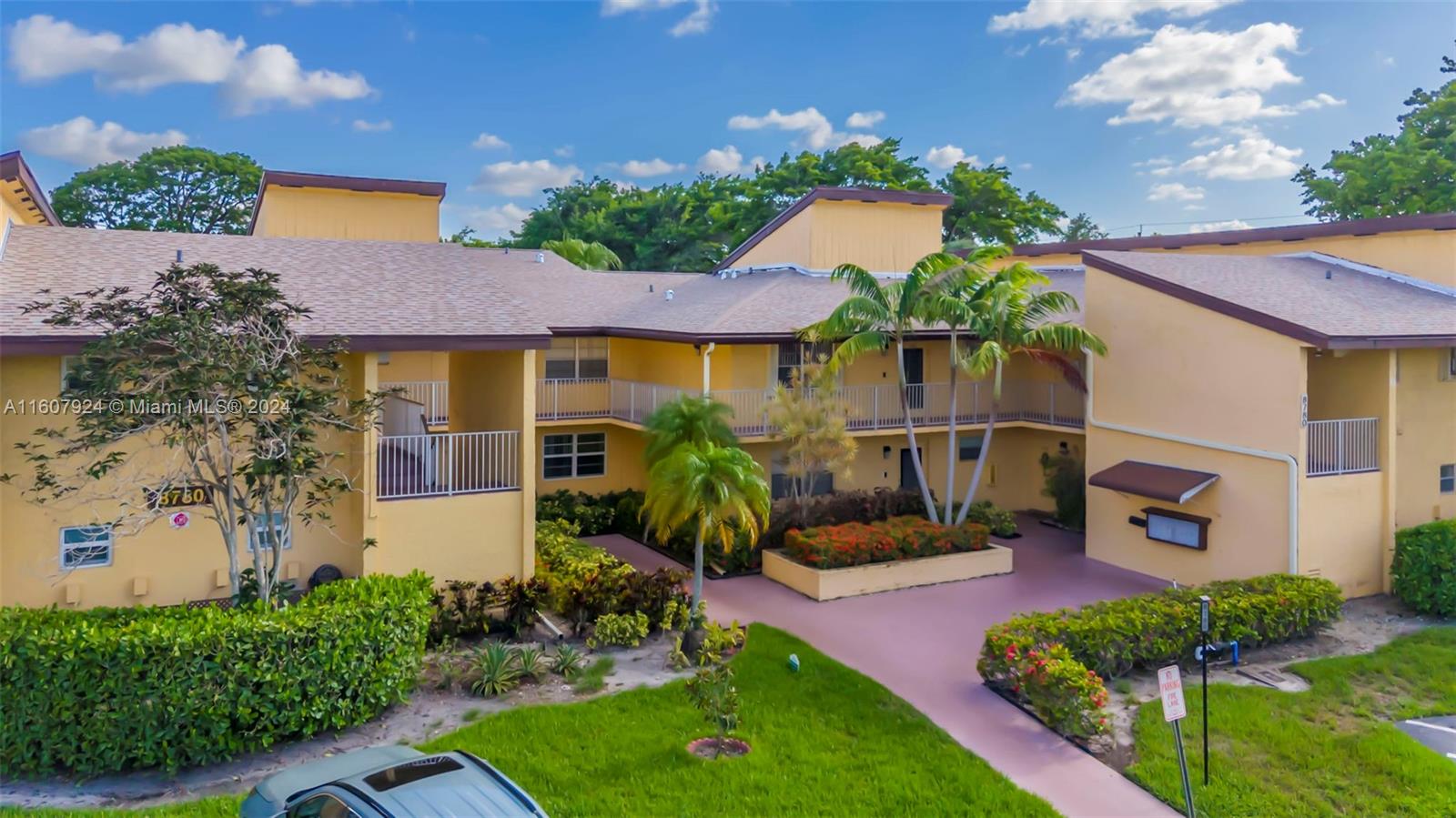 8780 Azalea Court, Unit 104 Tamarac, FL 33321 - Photo 18 of 37 a front view of a house with garden