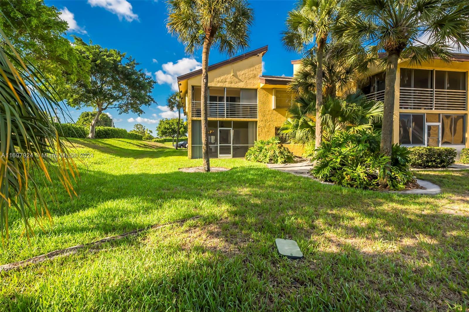 8780 Azalea Court, Unit 104 Tamarac, FL 33321 - Photo 21 of 37 a view of a house with a yard