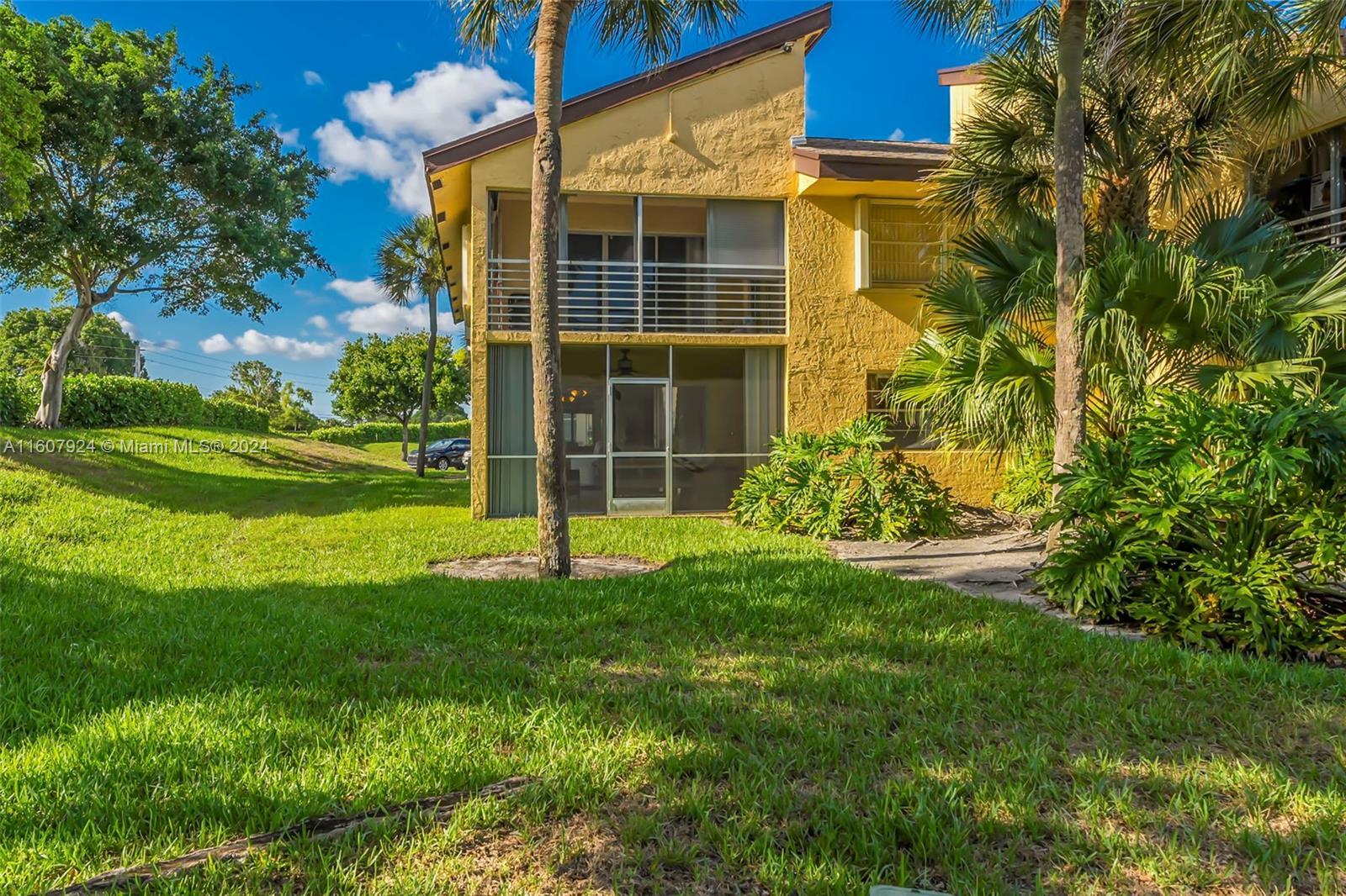 8780 Azalea Court, Unit 104 Tamarac, FL 33321 - Photo 22 of 37 a view of a house with a yard and sitting area