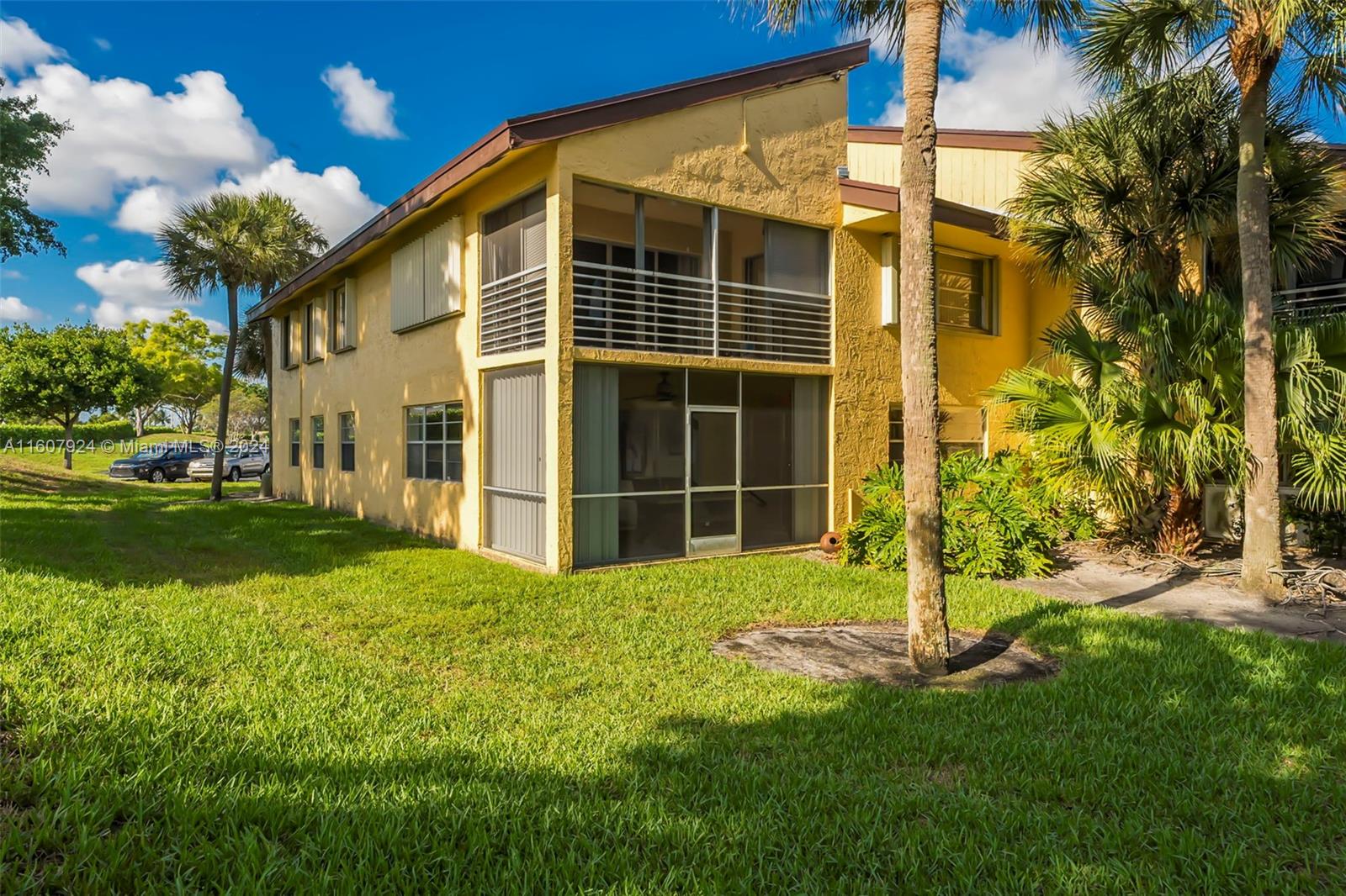 8780 Azalea Court, Unit 104 Tamarac, FL 33321 - Photo 23 of 37 a view of a house with backyard