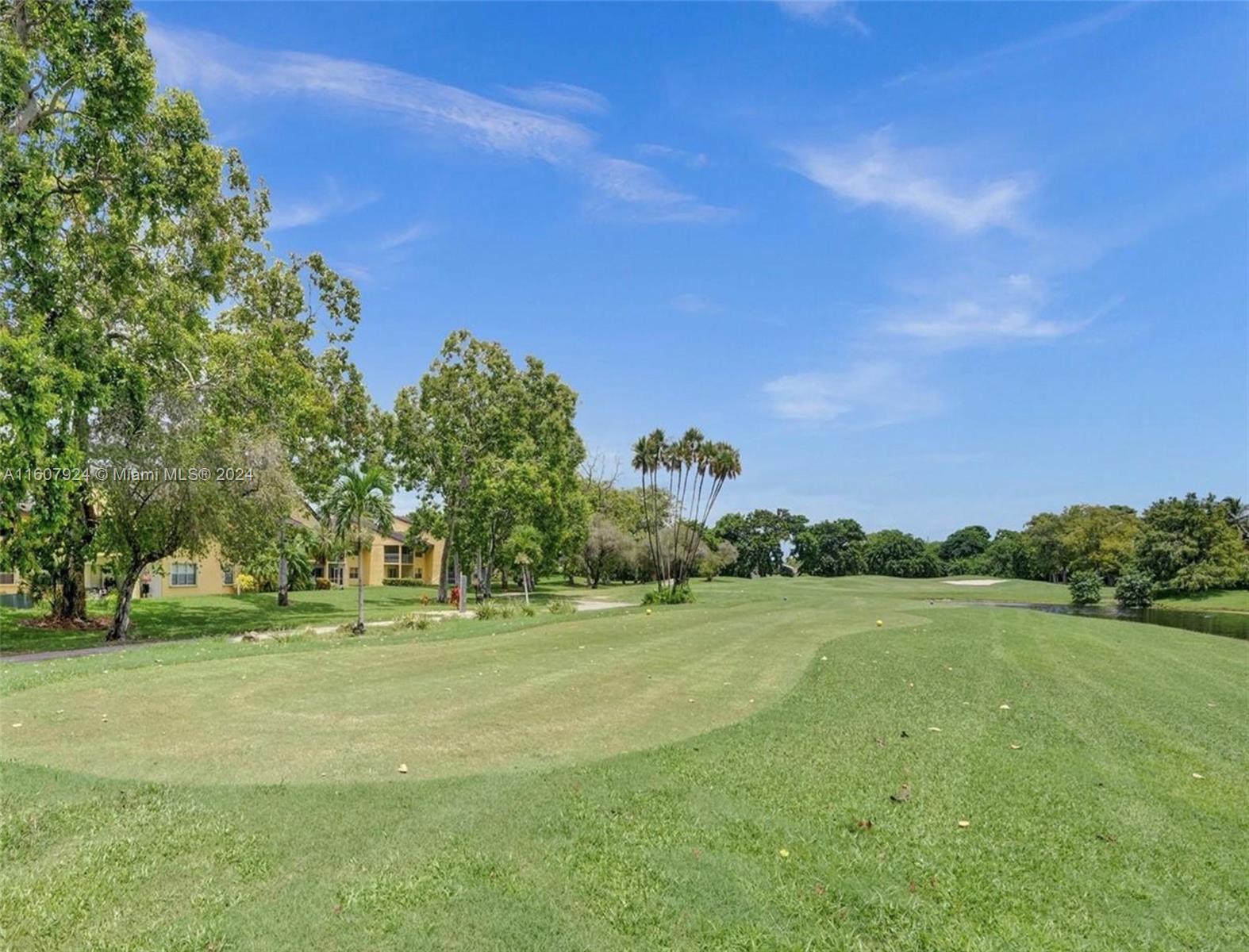 8780 Azalea Court, Unit 104 Tamarac, FL 33321 - Photo 30 of 37 a garden view with a play ground