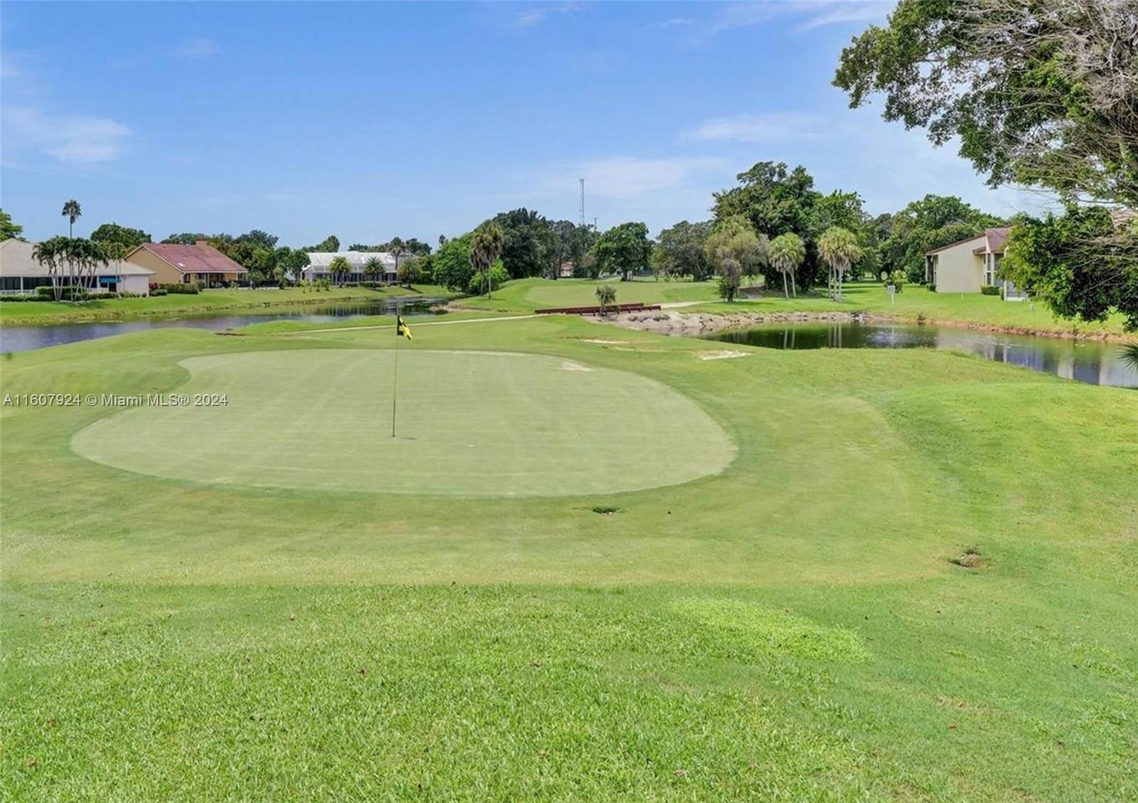 8780 Azalea Court, Unit 104 Tamarac, FL 33321 - Photo 31 of 37 a view of a golf course with a lake
