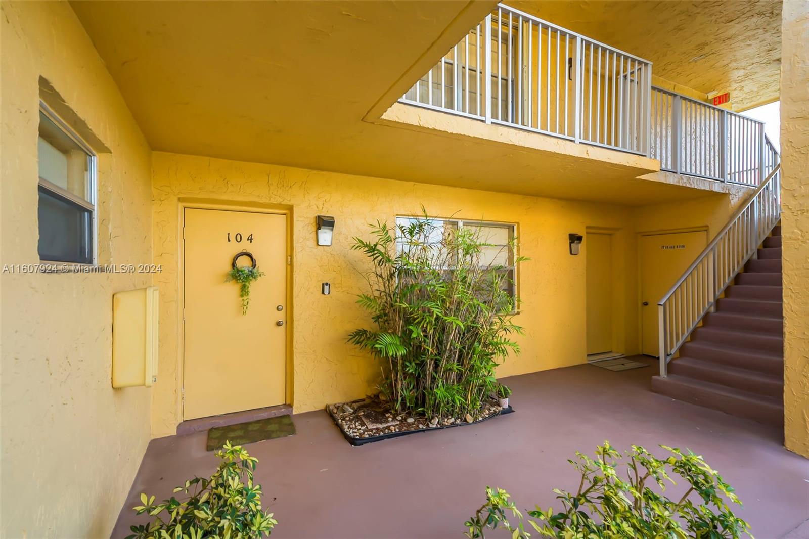 8780 Azalea Court, Unit 104 Tamarac, FL 33321 - Photo 5 of 37 a front view of a house with a yard