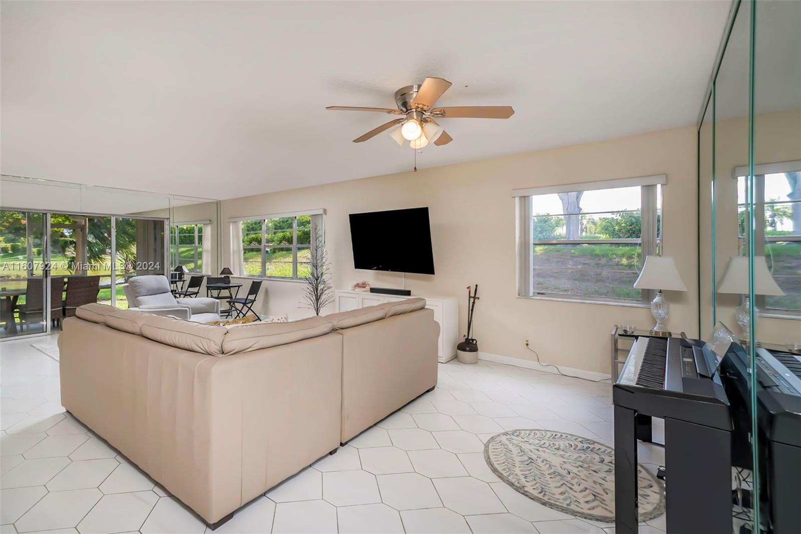 8780 Azalea Court, Unit 104 Tamarac, FL 33321 - Photo 10 of 37 a living room with furniture and a flat screen tv