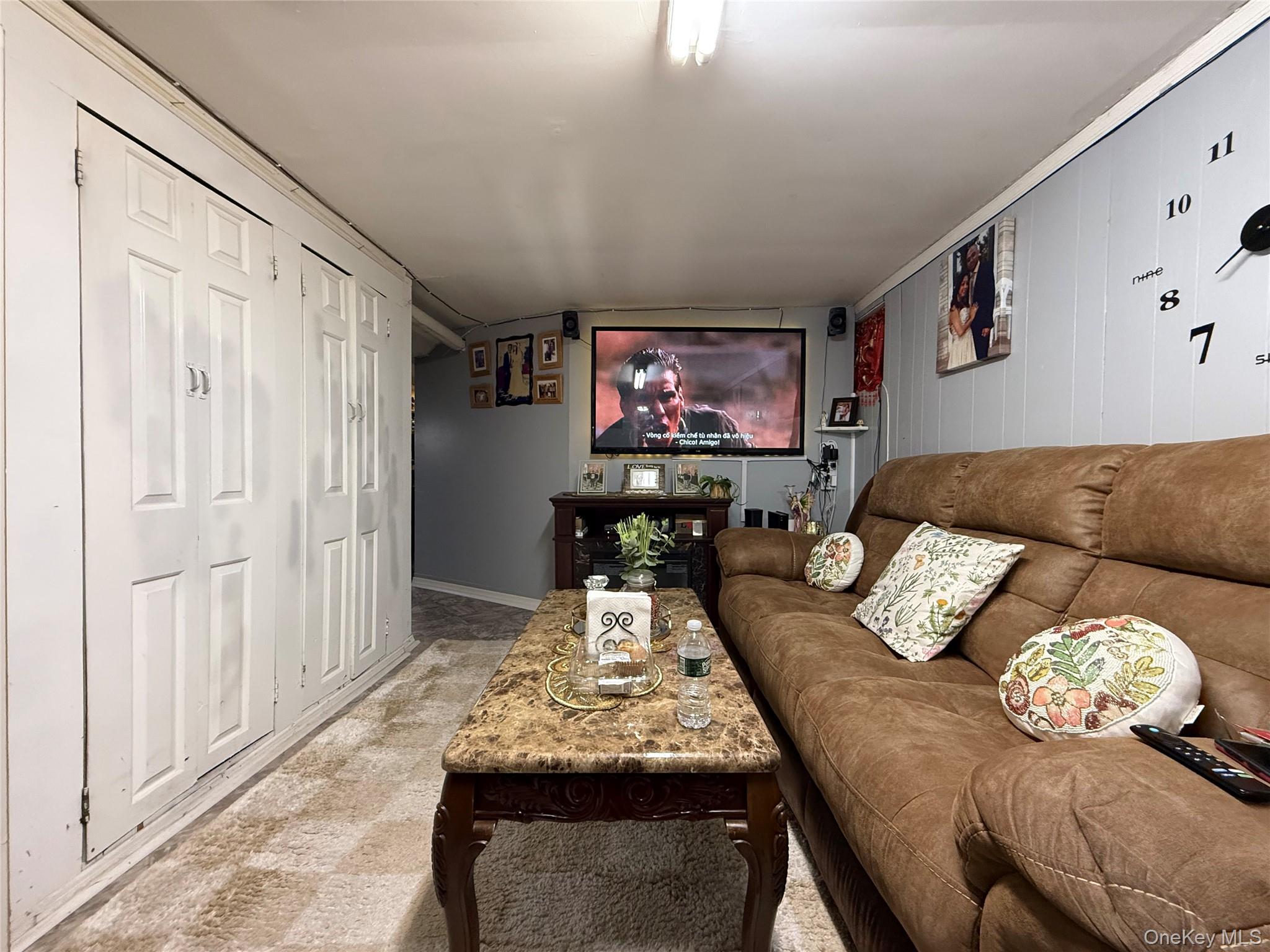 90-13 77th Street Queens, NY 11421 - Photo 14 of 16 a living room with furniture and furniture