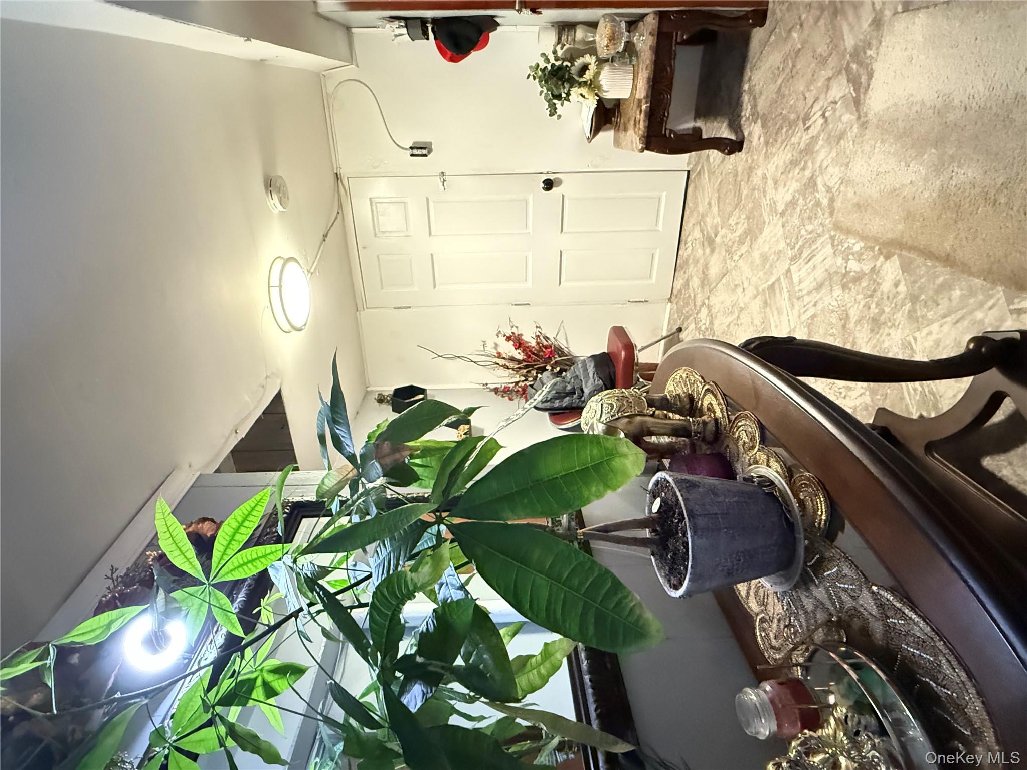 90-13 77th Street Queens, NY 11421 - Photo 15 of 16 a view of a dining room with furniture