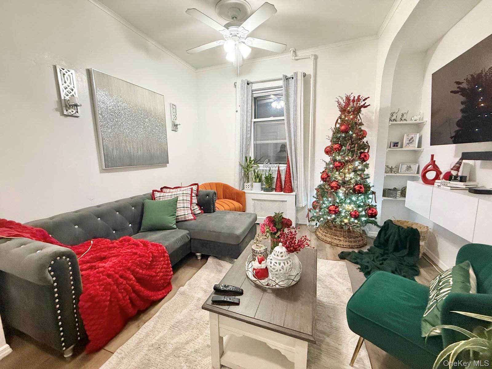 90-13 77th Street Queens, NY 11421 - Photo 4 of 16 a living room with furniture and flowers