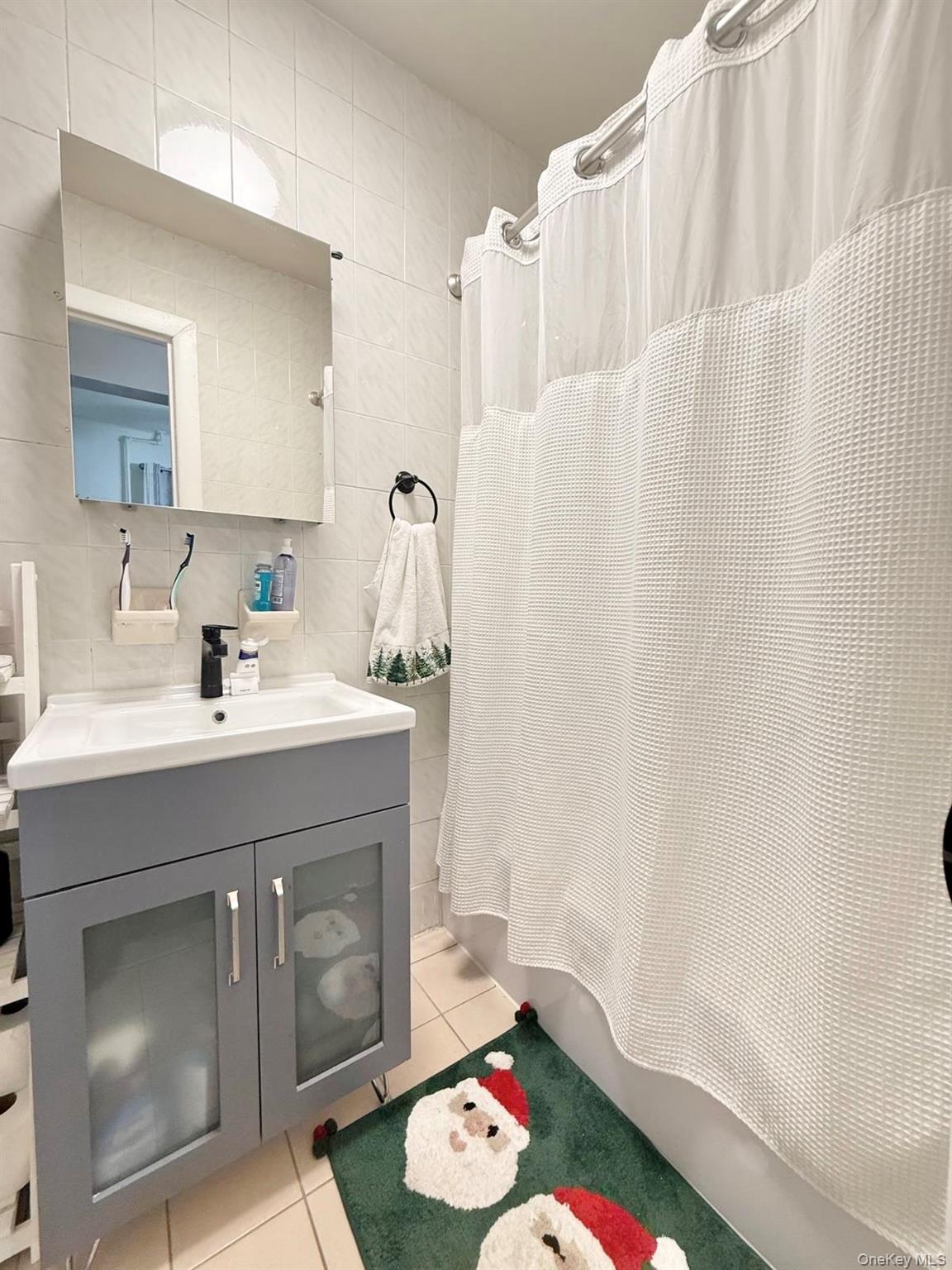 90-13 77th Street Queens, NY 11421 - Photo 6 of 16 a bathroom with a sink toilet and shower