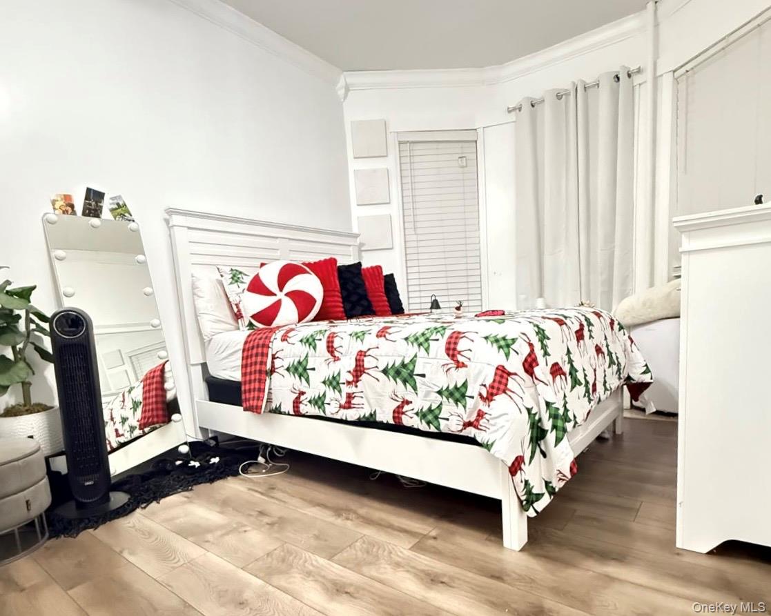 90-13 77th Street Queens, NY 11421 - Photo 7 of 16 a bedroom with a bed and a window