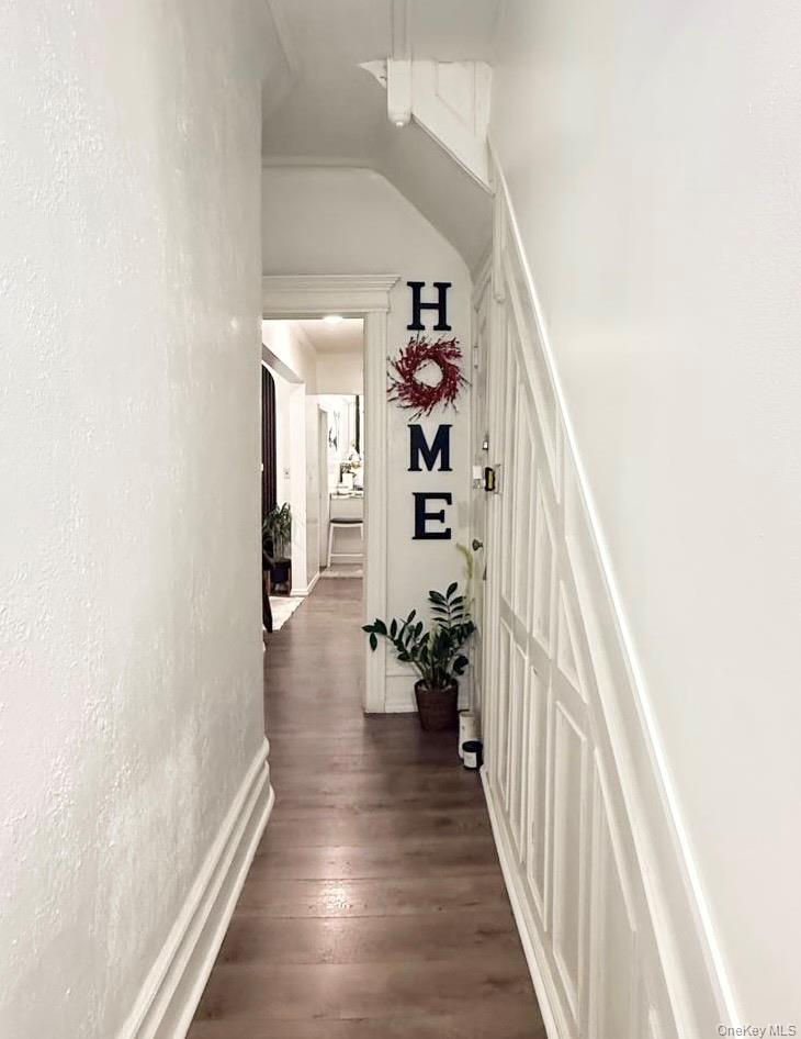 90-13 77th Street Queens, NY 11421 - Photo 10 of 16 a view of a hallway with wooden floor and entryway