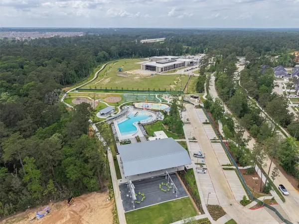an aerial view of a house with swimming pool and mountains
