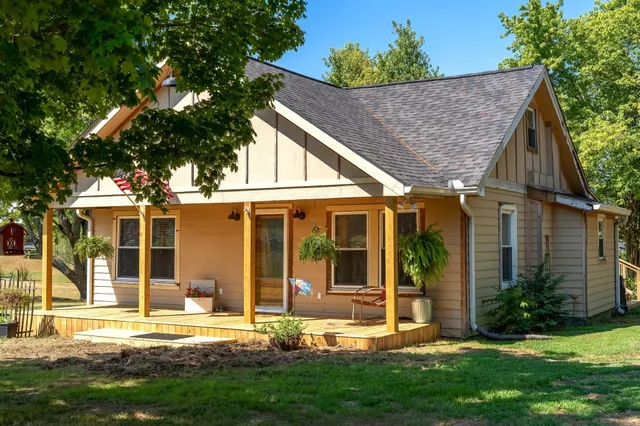 an aerial view of a house with a yard