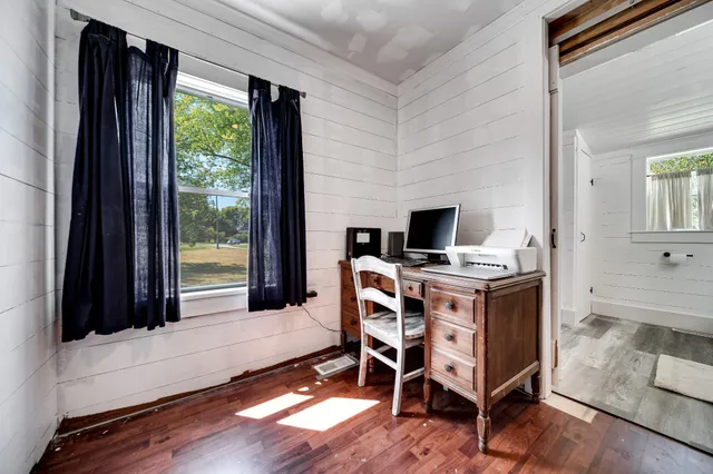 a living room with furniture and kitchen view