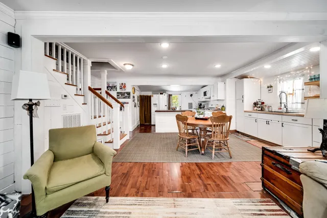 a view of a room with furniture and wooden floor