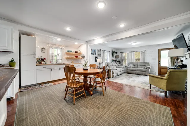 a bathroom with a granite countertop sink a mirror a shower and a bathtub