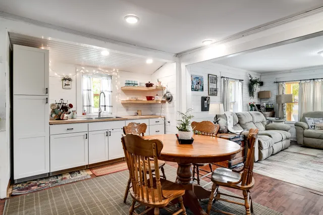a view of entryway with furniture and wooden floor