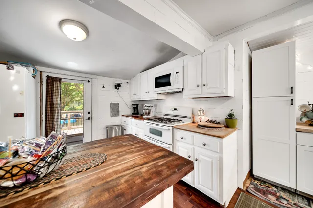 a view of a field with trees in the background
