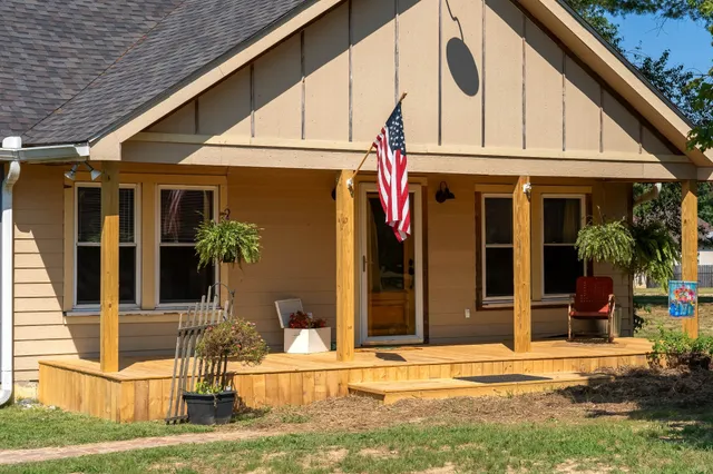 a view of a small house with swimming pool in front of it