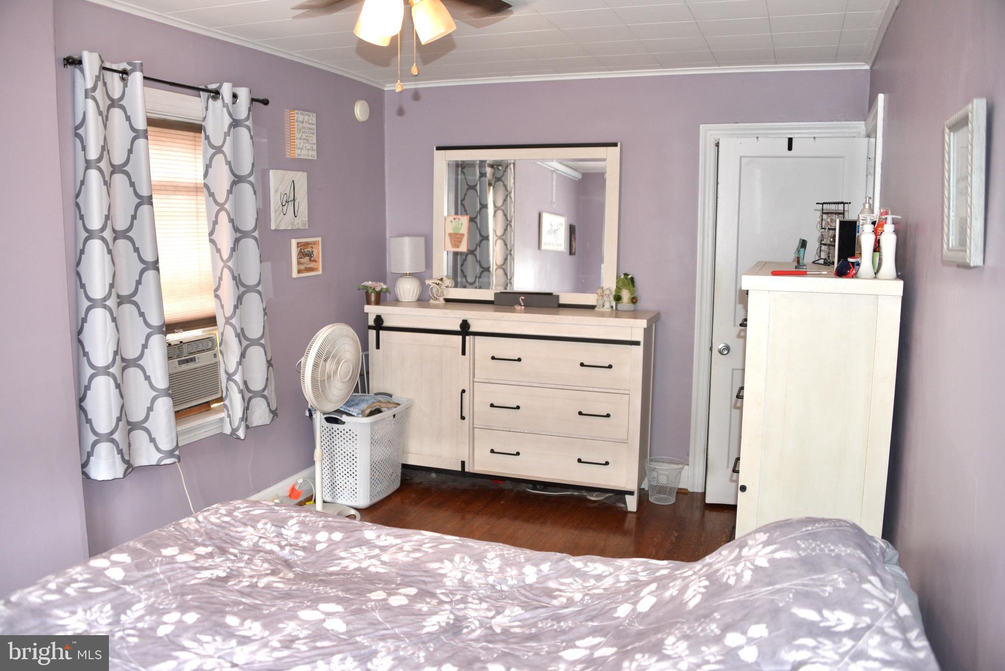 2545 Grant Street Reading, PA 19606 - Photo 13 of 25 a room with a baby crib a dresser and a chandelier