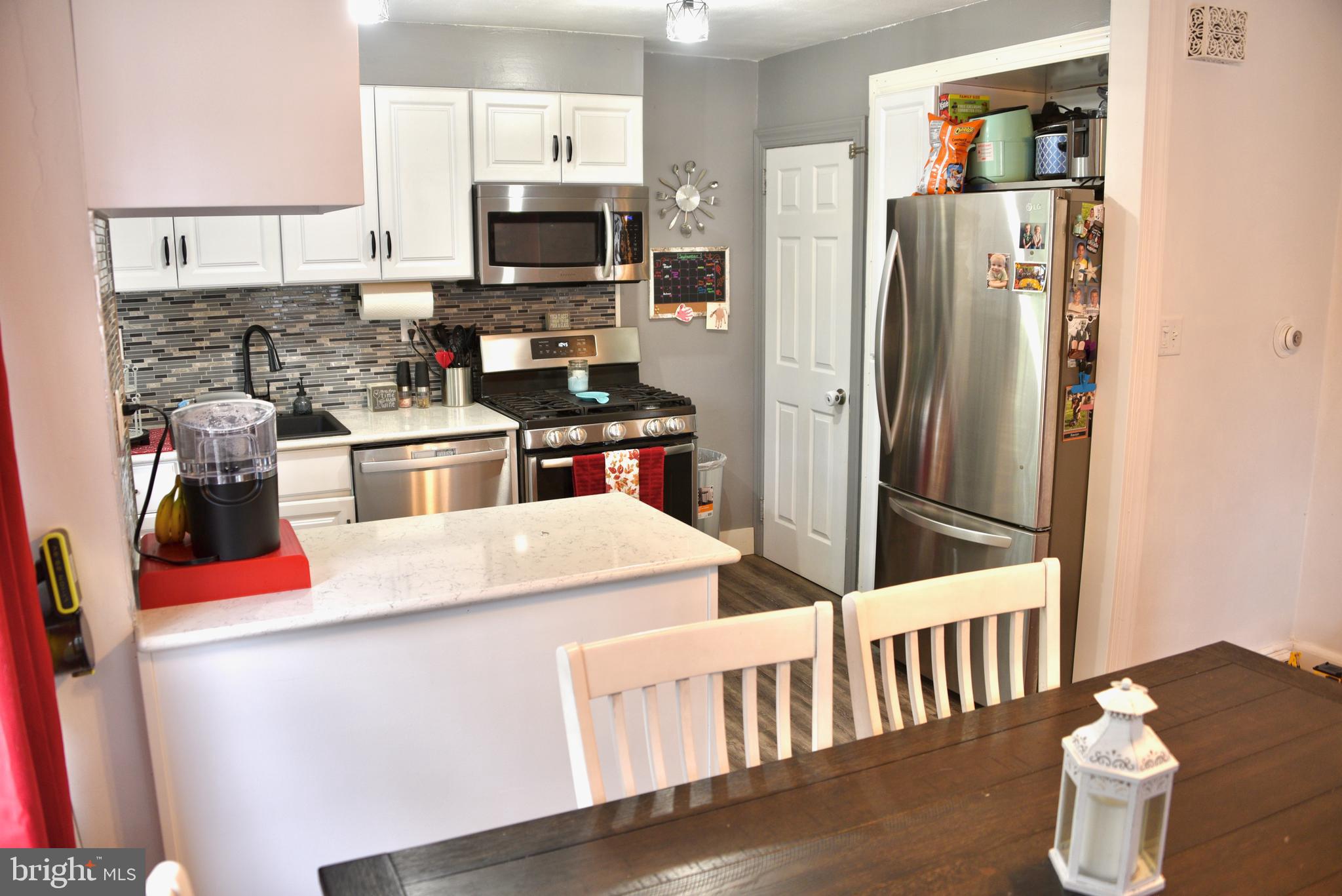 2545 Grant Street Reading, PA 19606 - Photo 7 of 25 a kitchen with stainless steel appliances kitchen island wooden floor and refrigerator