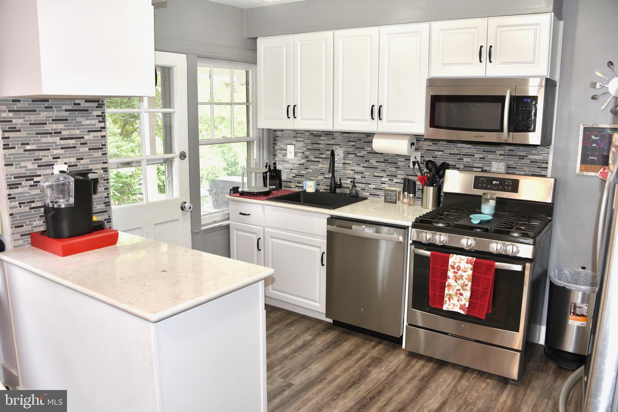 2545 Grant Street Reading, PA 19606 - Photo 8 of 25 a kitchen with stainless steel appliances granite countertop a stove top oven a sink dishwasher and a microwave oven with cabinets