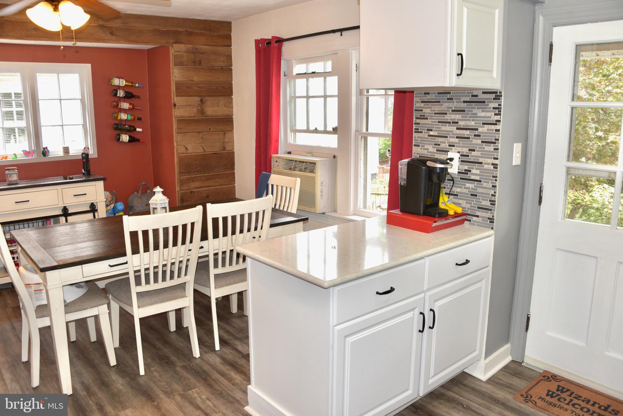 2545 Grant Street Reading, PA 19606 - Photo 10 of 25 a kitchen with stainless steel appliances kitchen island granite countertop a stove a sink and a dining table with wooden cabinet