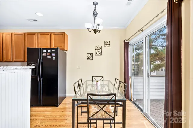 a dining room with furniture a rug and a chandelier