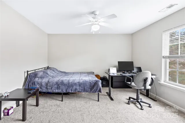 a view of walk in closet with clothes