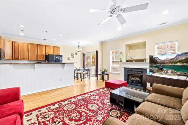 a living room with stainless steel appliances kitchen island granite countertop furniture and a couch