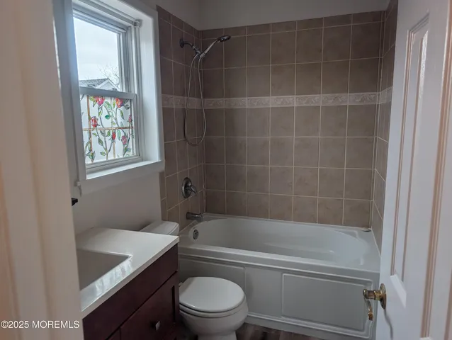 a bathroom with a sink vanity and toilet