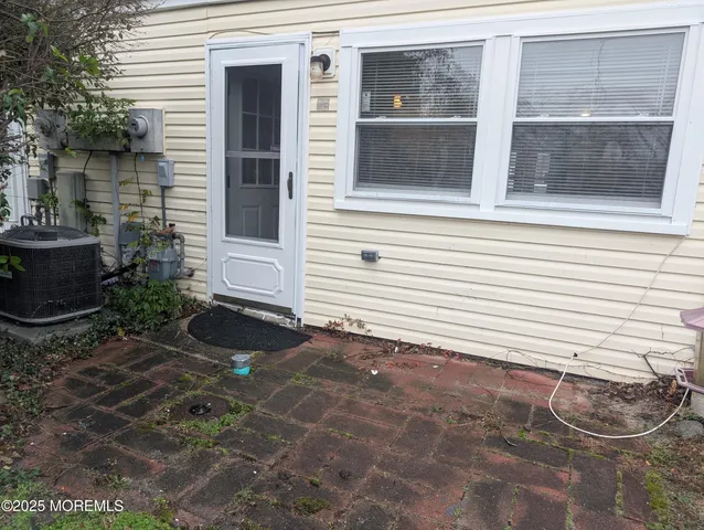 a front view of a house with a yard and potted plants