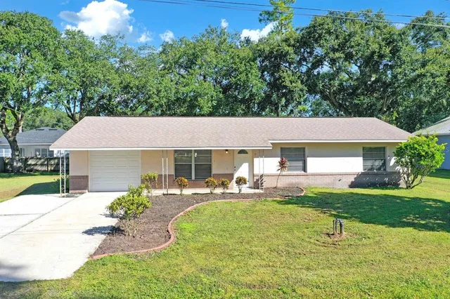 a front view of house with yard and outdoor seating