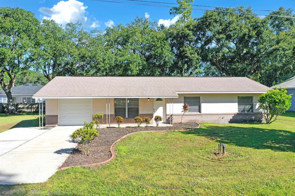 a front view of house with yard and outdoor seating