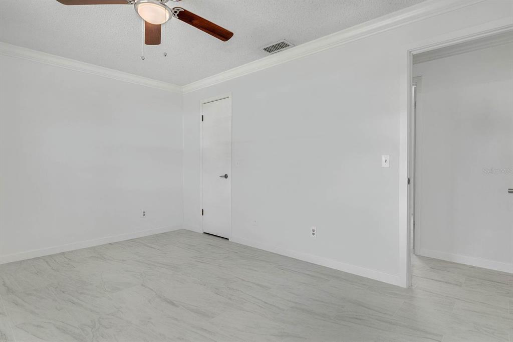 6449 Eve Street St. Cloud, FL 34771 - Photo 16 of 25 an empty room with a ceiling fan and window