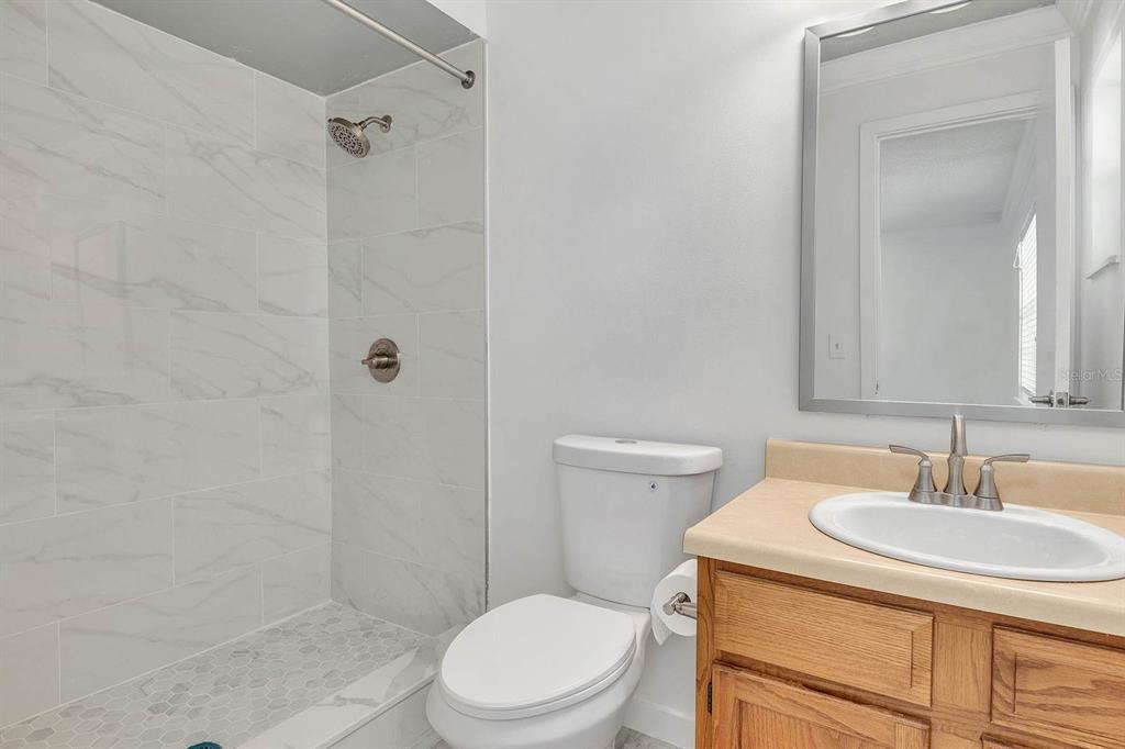 6449 Eve Street St. Cloud, FL 34771 - Photo 18 of 25 a bathroom with a sink a toilet and shower